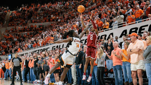 Feb 24, 2024; Stillwater, Oklahoma, USA; Oklahoma Sooners guard Javian McCollum (2) shoots the ball over Oklahoma State Cowboys guard Jamyron Keller (14) to win the game in overtime at Gallagher-Iba Arena. Mandatory Credit: William Purnell-USA TODAY Sports